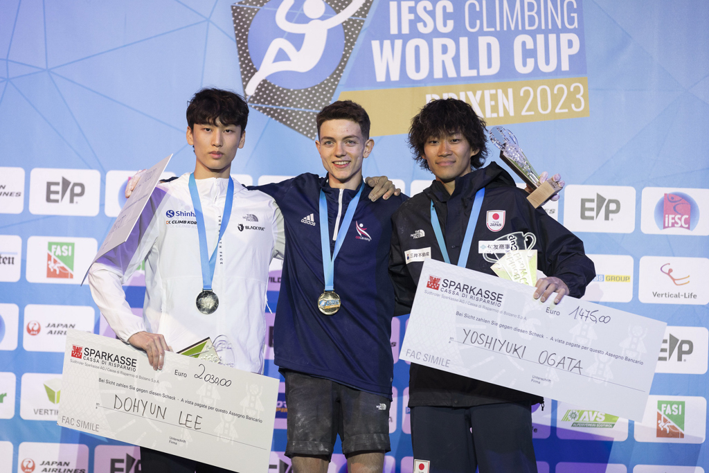 The men's podium at Brixen with Toby Roberts – winner of the first ever Boulder Gold by a British climber. Photo: Dimitris Tosidis/IFSC