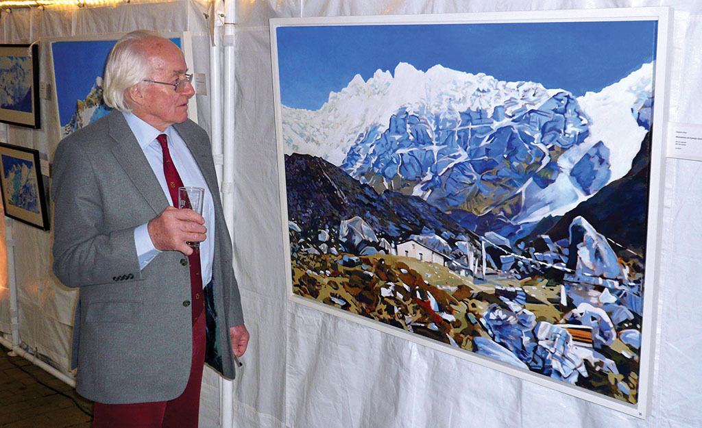 Doug Scott looks at a painting of the Langtang Valley by Stephen King during a talk at the Nepalese Embassy in 2017. Photo: Noel Dawson