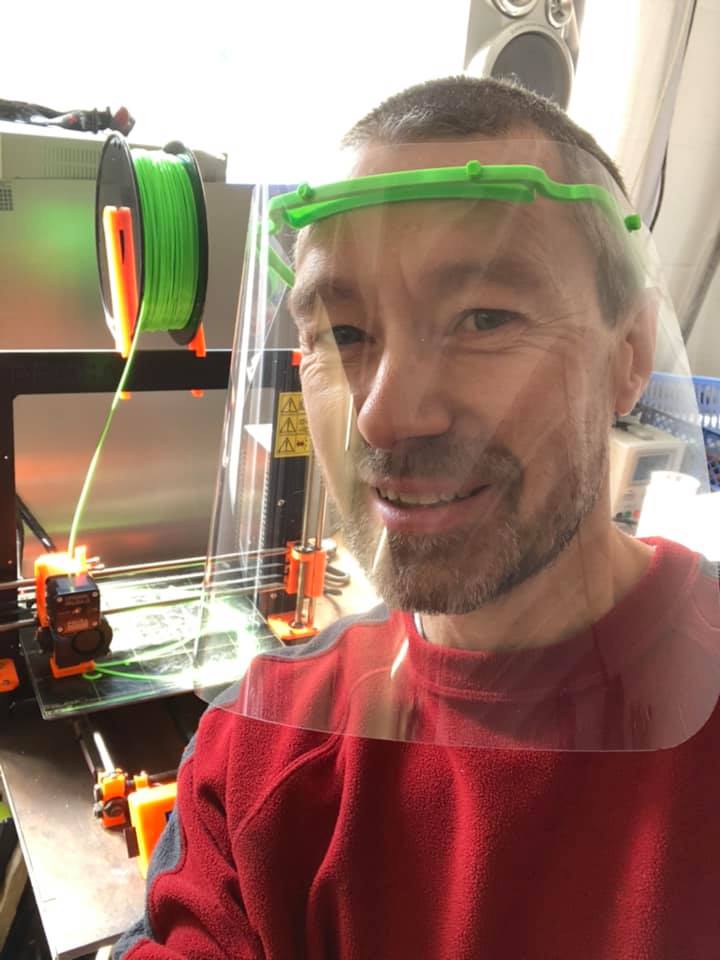 Martin Roberts using his 3D printer to produce the headbands for the face masks. Photo: Martin Roberts