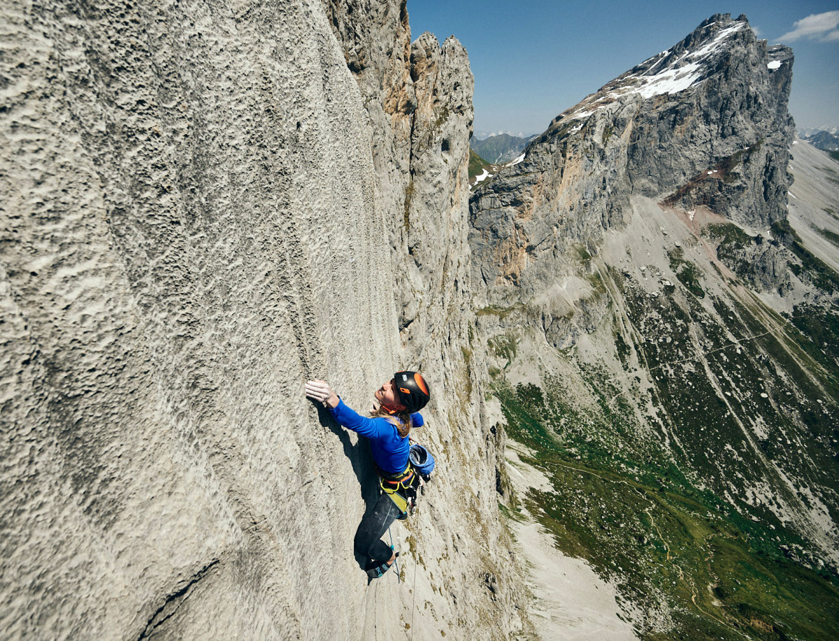 Lara Neumeier high on Silbergeier (F8b+) on the Kirchlispitze in the Rätikon range of Switzerland. Photo: © Ray Demski (@raydemski)