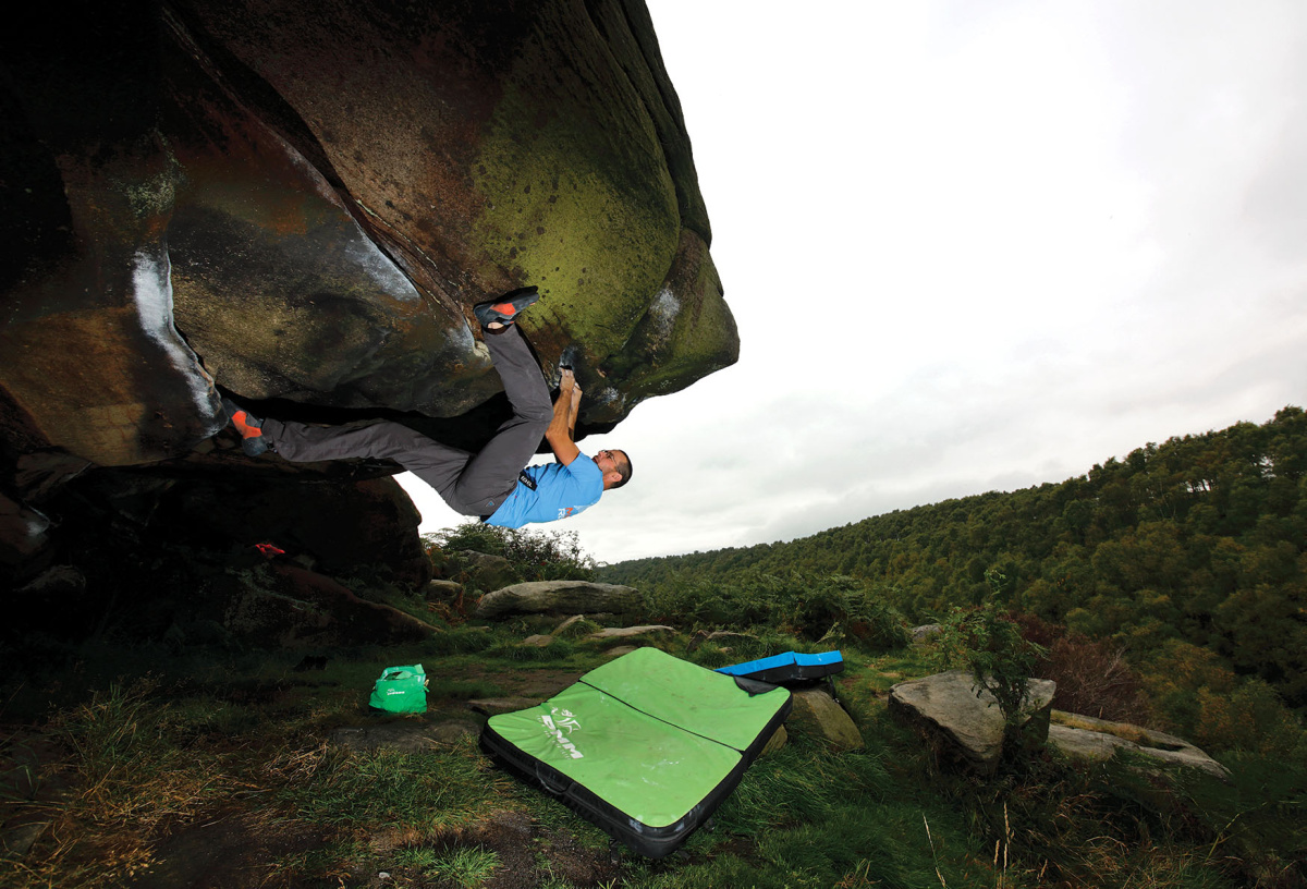 Gareth Parry gets involved with a burly problem graded (Font 6C+) and called Mark's Roof Left-Hand traversing all the way to the end of the roof to the right. Photo: © David Simmonite