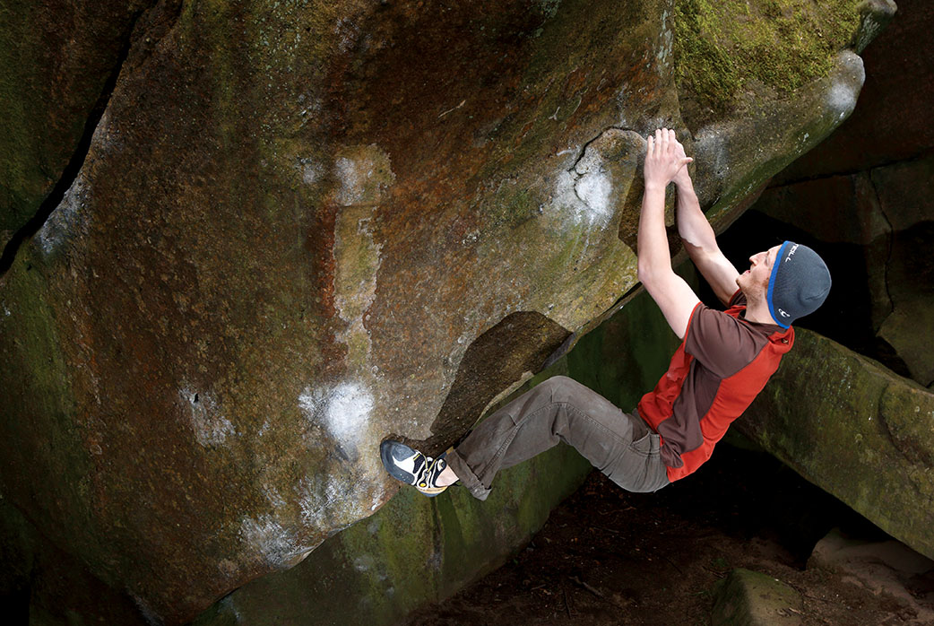 Tucked away on the back of the Cubic Slab is this quality problem. Cubic is climbed from a standing start at Font 6a+. Adam Hetherington climbing. Photo: © David Simmonite